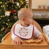 bambino con bavaglino natalizio e il suo biscotto di pasta frolla