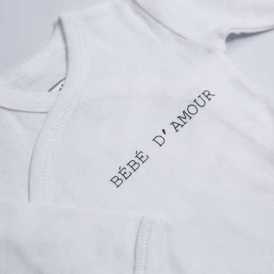 White baby bodysuit with "love baby" inscription