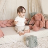 zittende baby met zijn decoratieve vlecht om zijn speelruimte te creëren