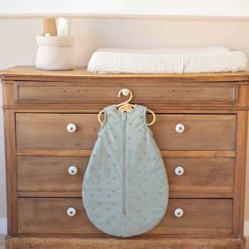sleeping bag displayed on baby dresser