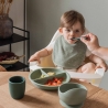 baby eating with newborn bib with savannah pattern