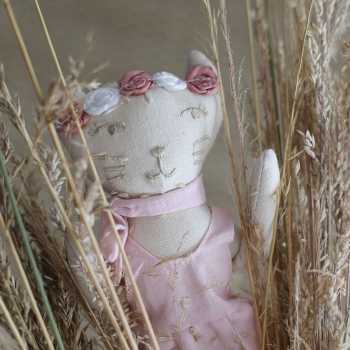 Linen cat doll in dried leaf