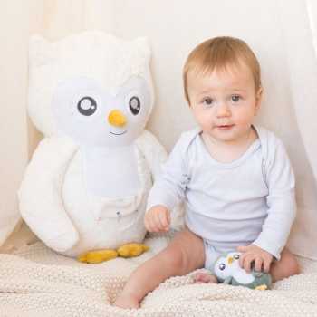 Violette plush toy next to baby in the play area