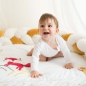 Baby boy laughing on activity mat