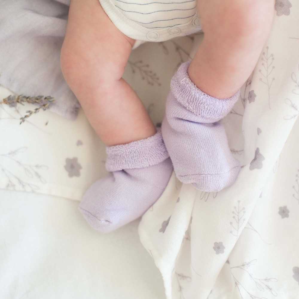 baby in purple socks