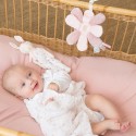 baby listening to the musical flower in their crib