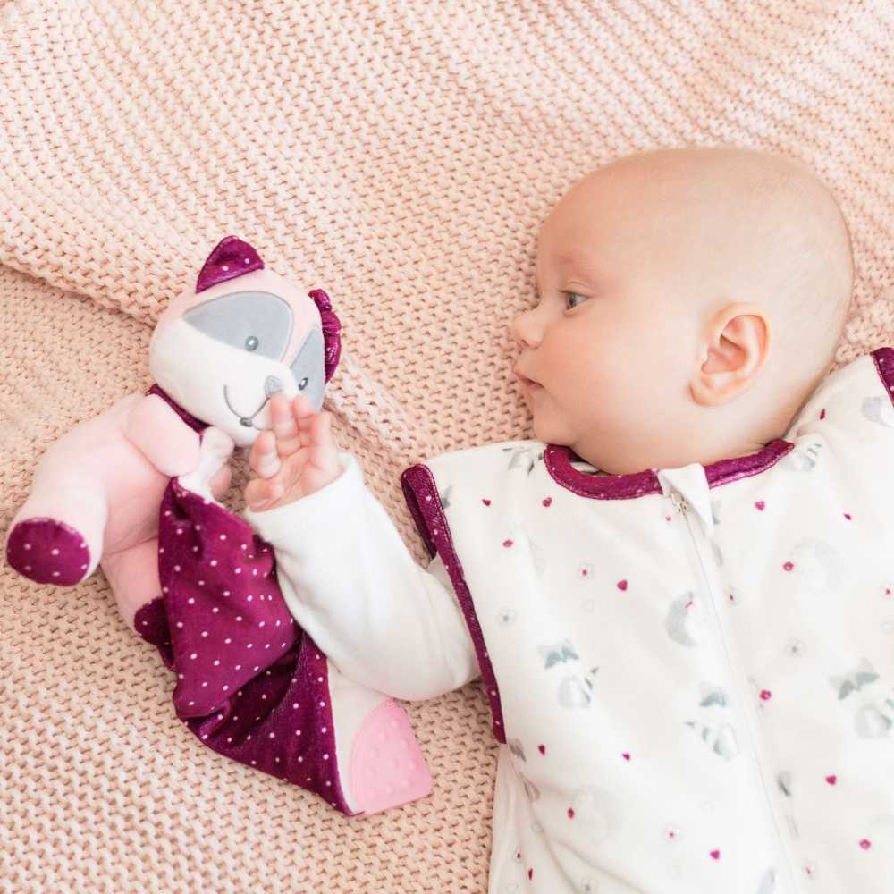neonato sdraiato con il suo pupazzo nella sua sacca nanna per neonati bianca e melanzana, collezione kipic