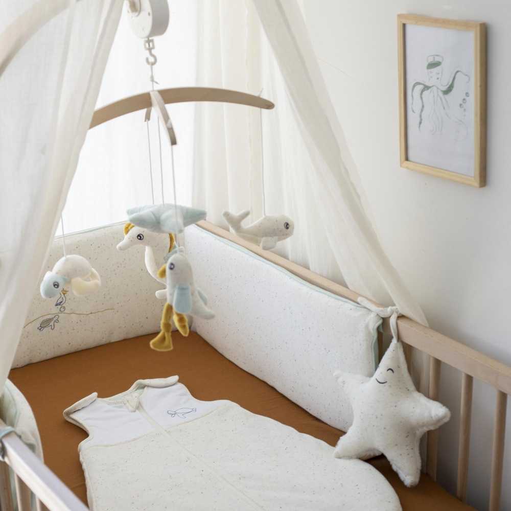 flecked sleeping bag at sea of nova staged with camel sheet