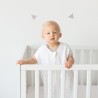 baby rechtop in zijn bedje met zomerslaapzak