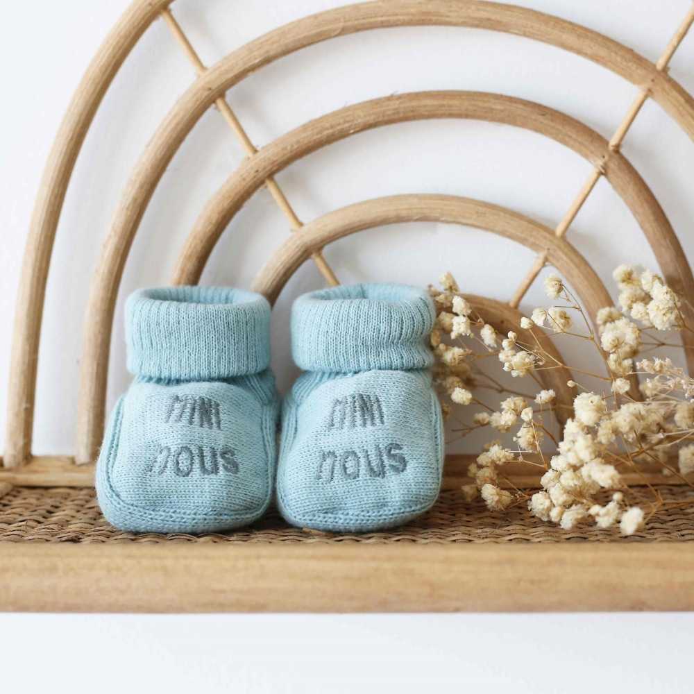 staging of sage green mini nous baby booties