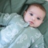 Baby awake in green sleeping bag with sleeves