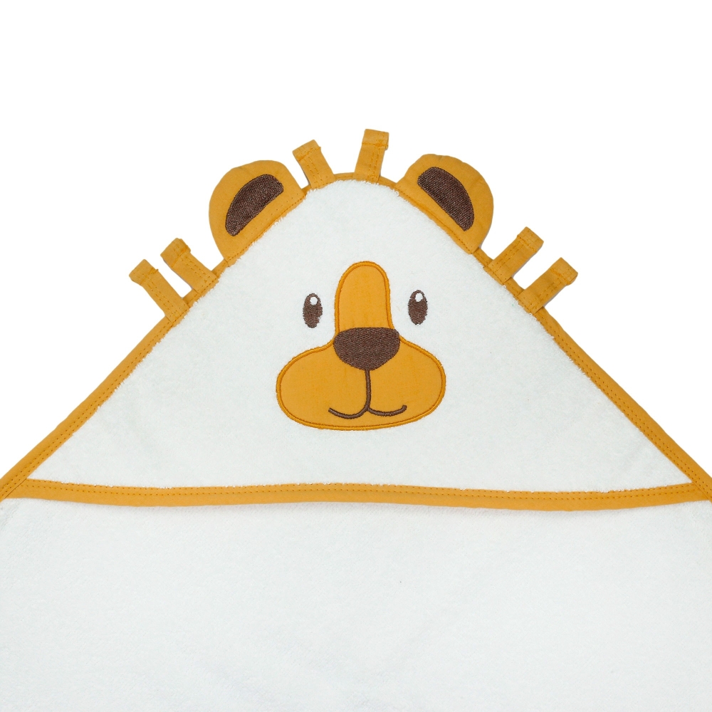 Close-up of the face and muzzle of the baby lion decorating the bath towel