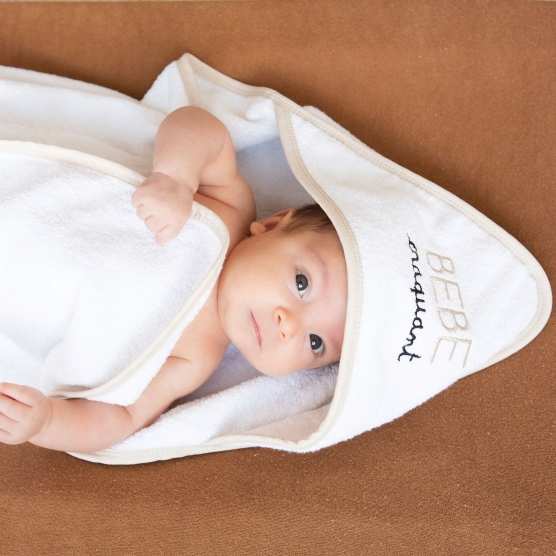 White irresistible baby hooded towel with beige trim